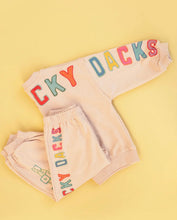 Childrens Track suit cream with colourful writing print long sleeve